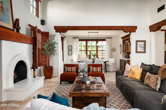 tiled living room featuring a high ceiling and a wealth of natural light