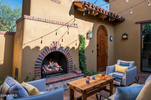 view of patio with an outdoor living space with a fireplace