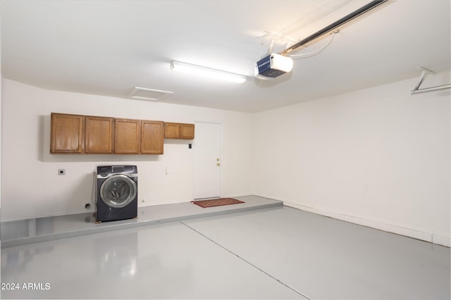 garage featuring washer / clothes dryer and a garage door opener