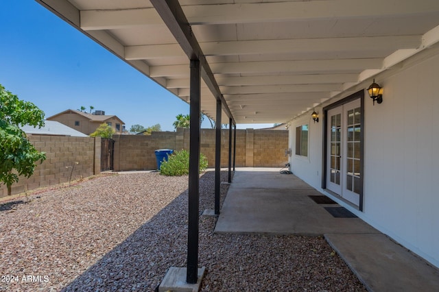 view of yard with french doors and a patio area