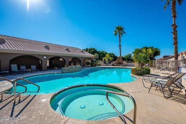 view of pool with a community hot tub and a patio