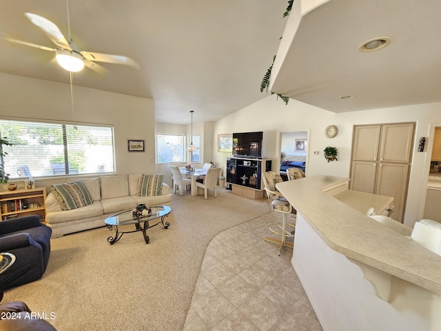 carpeted living room featuring ceiling fan and vaulted ceiling