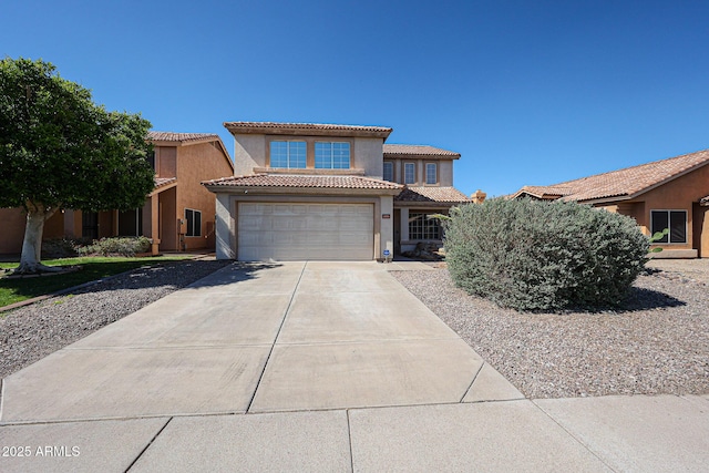 4306 E Raven Rd, Phoenix, AZ 85044 - mediterranean / spanish-style home featuring driveway, stucco siding, a tile roof, and an attached garage