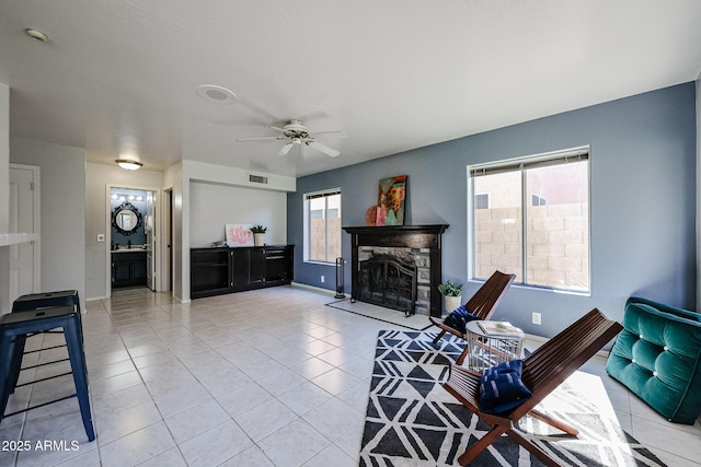 4306 E Raven Rd, Phoenix, AZ 85044 - tiled living area featuring a fireplace, a ceiling fan, and baseboards