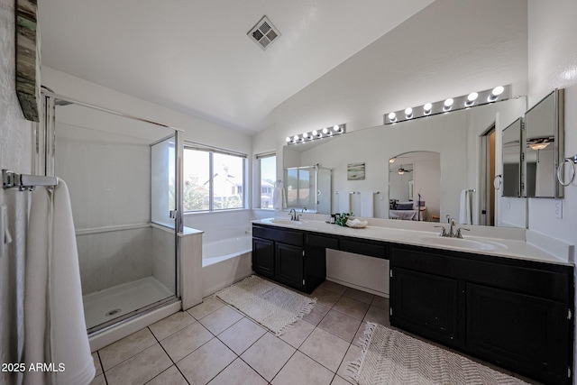 4306 E Raven Rd, Phoenix, AZ 85044 - full bathroom featuring lofted ceiling, a shower stall, a garden tub, double vanity, and tile patterned flooring
