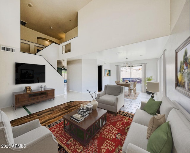 4306 E Raven Rd, Phoenix, AZ 85044 - living area featuring a towering ceiling, light tile patterned floors, and a chandelier