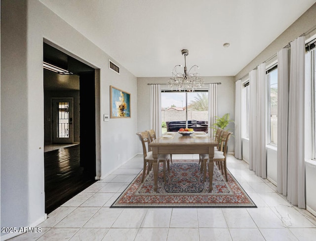 4306 E Raven Rd, Phoenix, AZ 85044 - dining room with a chandelier and light tile patterned floors