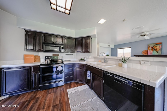 4306 E Raven Rd, Phoenix, AZ 85044 - kitchen featuring black appliances, a sink, a peninsula, dark wood-style floors, and a ceiling fan