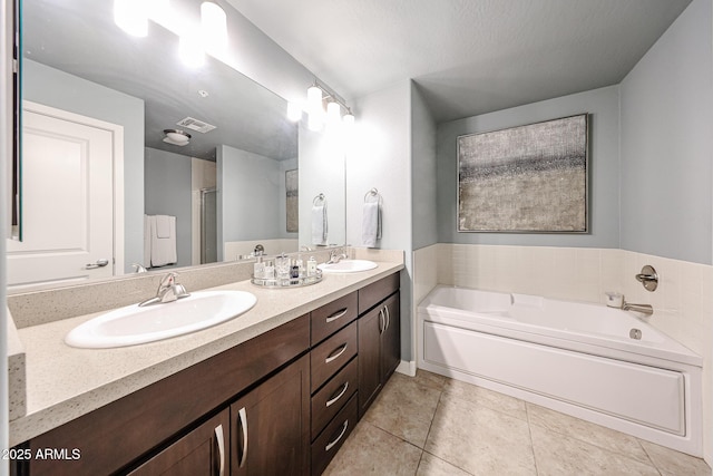 bathroom featuring a sink, visible vents, a bath, and double vanity