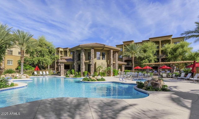pool with a patio and fence