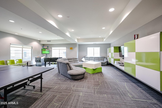 carpeted living area featuring recessed lighting, visible vents, and a raised ceiling