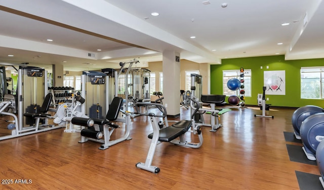workout area with recessed lighting and wood finished floors