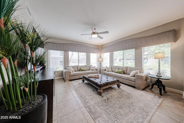 living area with light tile patterned floors, baseboards, and a ceiling fan