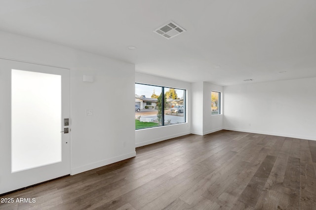 743 E Sierra Vista Dr, Phoenix, AZ 85014 - spare room with baseboards, visible vents, and wood finished floors