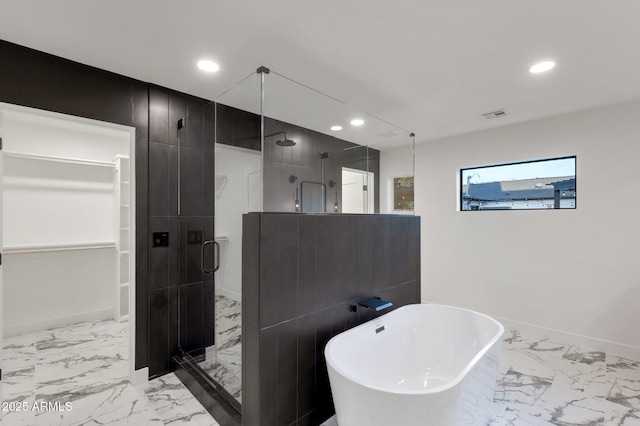 bathroom with marble finish floor, recessed lighting, visible vents, a freestanding bath, and a shower stall