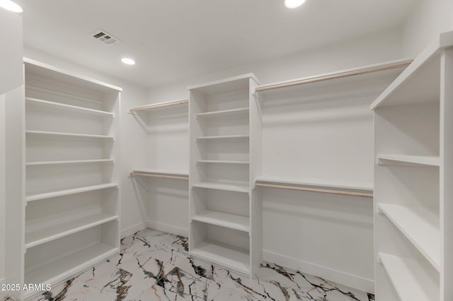 walk in closet with marble finish floor and visible vents