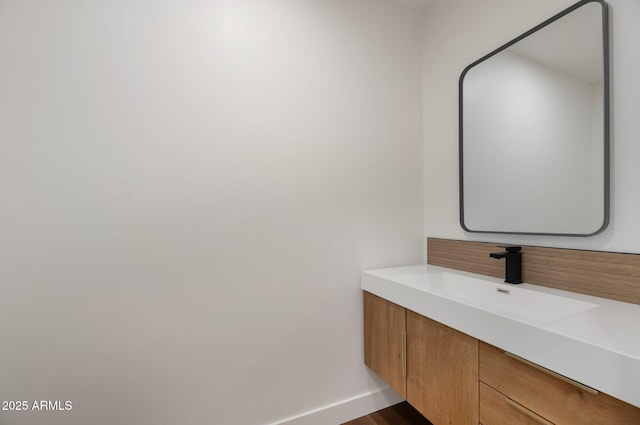 bathroom with vanity and baseboards