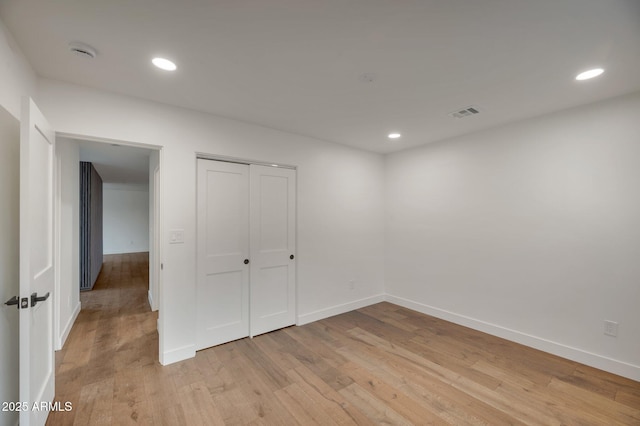 unfurnished bedroom featuring light wood-style floors, recessed lighting, and baseboards