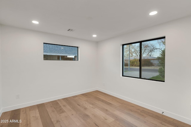 unfurnished room featuring light wood-style flooring, baseboards, and recessed lighting