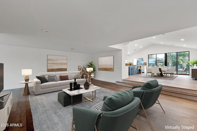 living area featuring vaulted ceiling, wood finished floors, and recessed lighting