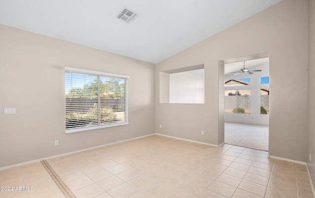 tiled empty room with vaulted ceiling and ceiling fan