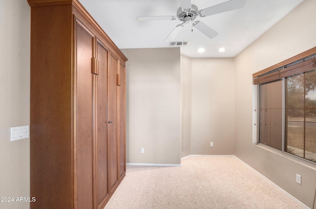 interior space with ceiling fan