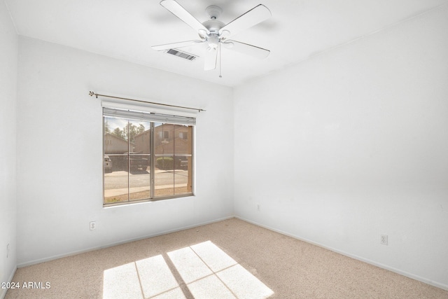 unfurnished room featuring light carpet and ceiling fan