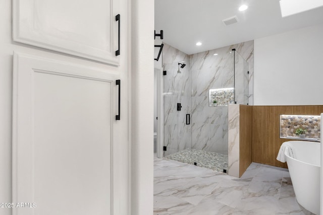 bathroom with marble finish floor, a marble finish shower, recessed lighting, visible vents, and a freestanding tub