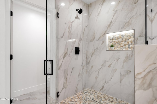 bathroom featuring marble finish floor and a marble finish shower