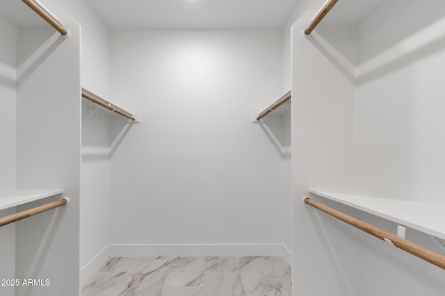 walk in closet with marble finish floor