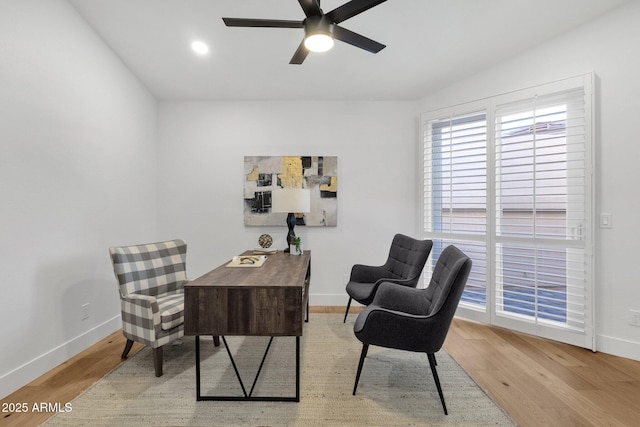 office featuring a ceiling fan, baseboards, and wood finished floors