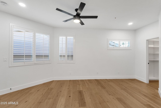 spare room with baseboards, recessed lighting, a ceiling fan, and light wood-style floors