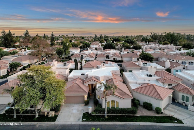 aerial view at dusk featuring a residential view