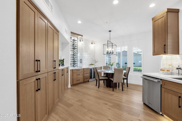 kitchen with light wood finished floors, tasteful backsplash, dishwasher, wine cooler, and recessed lighting