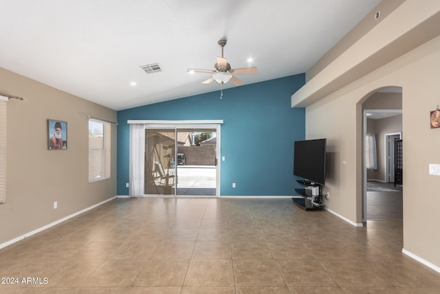 unfurnished living room featuring tile patterned flooring, lofted ceiling, and a wealth of natural light