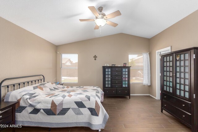 bedroom featuring hardwood / wood-style flooring, lofted ceiling, and ceiling fan