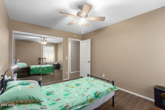 bedroom with dark hardwood / wood-style flooring, a closet, and ceiling fan