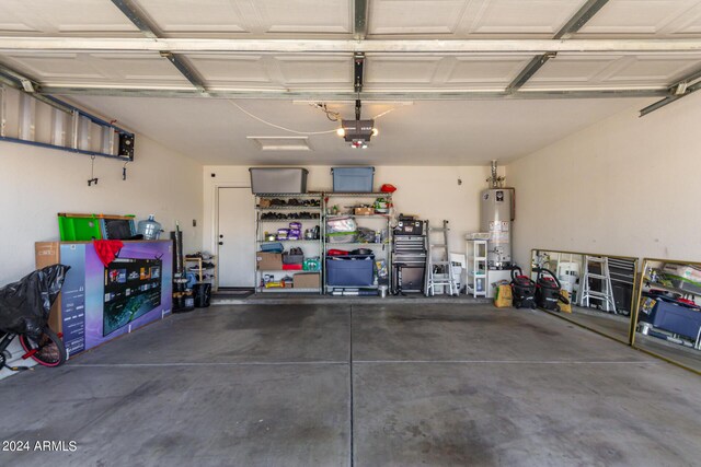 garage featuring water heater and a garage door opener