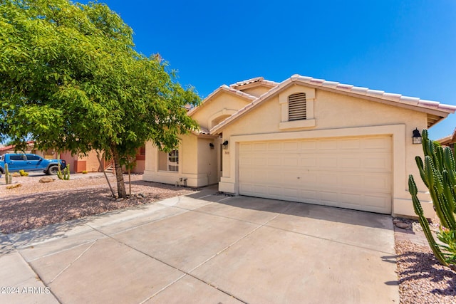 745 E Megan St, Chandler, AZ 85225 - view of front of house featuring driveway, an attached garage, a tiled roof, and stucco siding