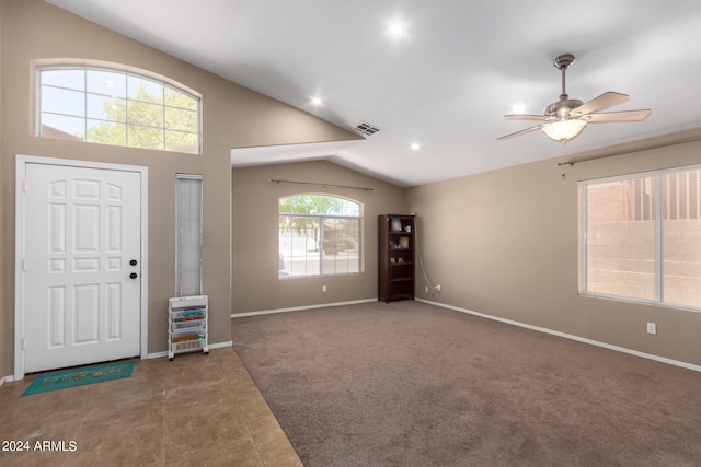 foyer entrance with lofted ceiling, carpet, and ceiling fan