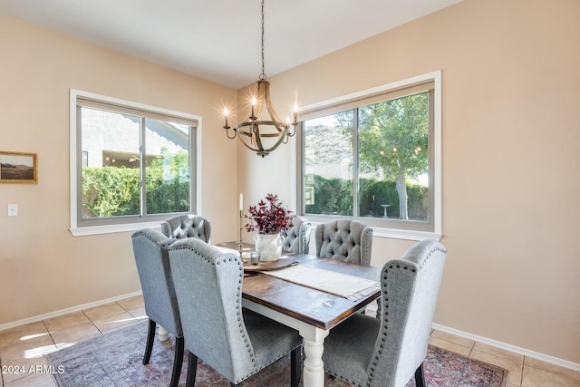 tiled dining area with a chandelier