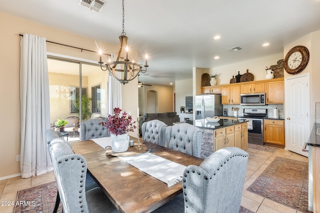 dining area with an inviting chandelier and light tile patterned flooring