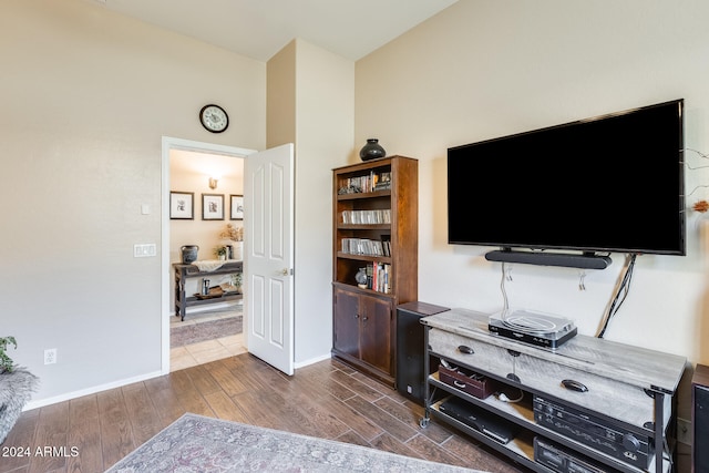 living room with dark hardwood / wood-style flooring and a high ceiling