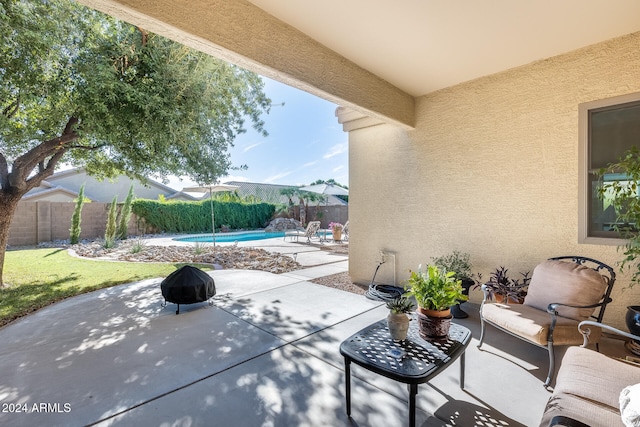 view of patio / terrace with a fenced in pool