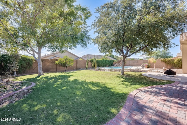 view of yard with a patio and a fenced in pool