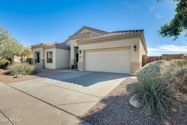 mediterranean / spanish-style home featuring a garage