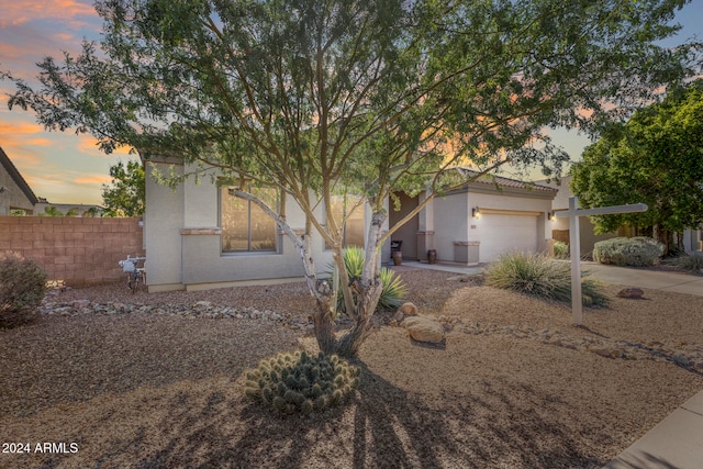 obstructed view of property with a garage