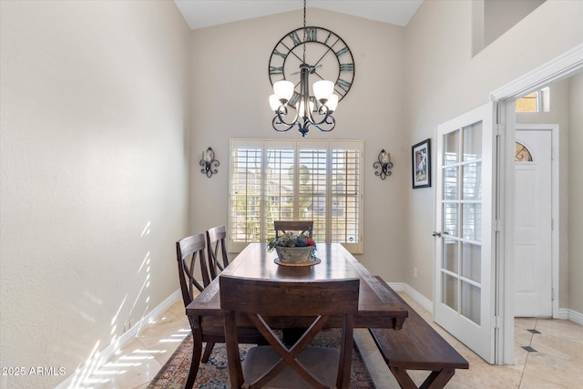 tiled dining space with a notable chandelier and high vaulted ceiling