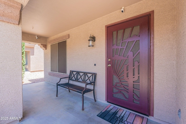 view of exterior entry featuring stucco siding