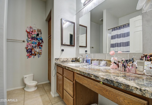 bathroom featuring vanity, toilet, and tile patterned flooring